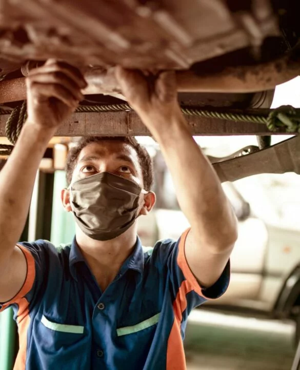 Technician working under a vehicle